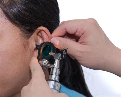 Ent Physician Checking Patients Ear Using Otoscope With An Inst