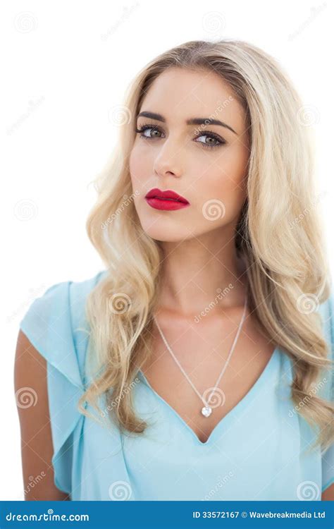 Thoughtful Blonde Model In Blue Dress Looking At Camera Stock Image