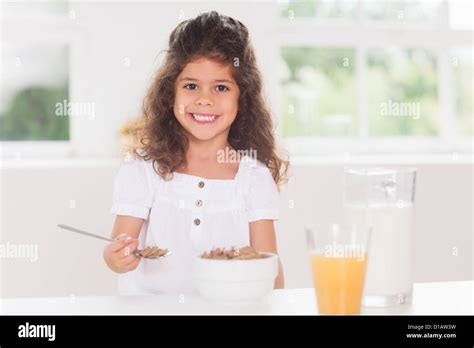 Little Girl Eating Cereal Stock Photo Alamy