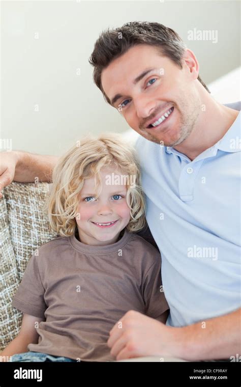 Father And Son Sitting On Sofa Stock Photo Alamy