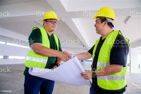 Engineer And Contractor Successful Deal Handshake On Construction Site