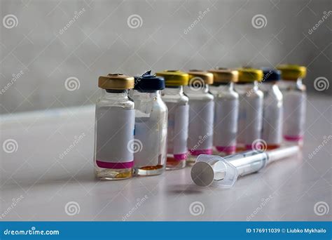 Antibiotic Bottles Are On A White Table With A Syringe Stock Image