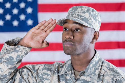 Soldier Saluting Standing Proud And Serious In Military Uniform Stock