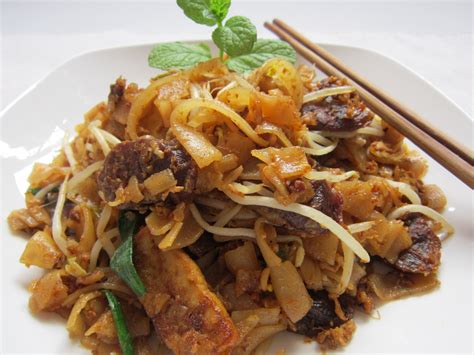 The actual char kway teow is the thin flat rice noodles mixed with little yellow noodles. my bare cupboard: Char Kuey Teow