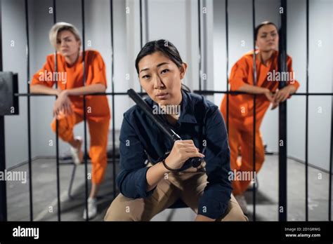 Three Girls In A Womens Prison A Guard And Two Criminals Pose For A