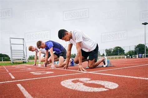 Runners At Starting Line On Running Track Stock Photo Dissolve