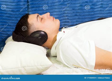 Young Man Relaxes Sleeps Listens To Music Stock Image Image Of Person