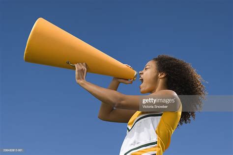 Female Cheerleader Shouting Into Megaphone Photo Getty Images