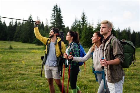 Friends Hiking Together Outdoors Exploring The Wilderness Stock Photo