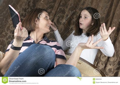 Mother And Daughter Arguing And Holding Tablet Stock Image Image Of