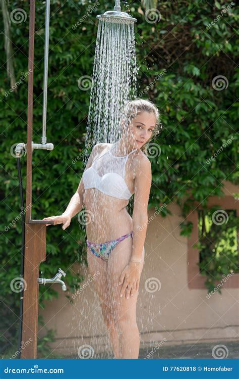Girl Wear Bikini Standing Under The Outdoor Pool Shower Stock Photo