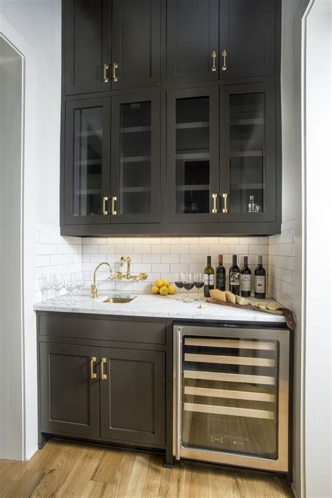 Save to favorites adina black cart with white concrete shelves. Black wet bar + wine fridge + white subway tile backsplash + black cabinets with brass hardware ...