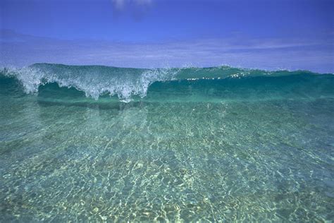 Hawaii Front View Of Shallow Crystal Clear Aquamarine Wave Curling