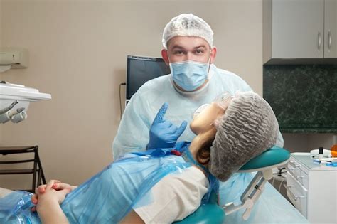 Premium Photo Dentist Doing A Dental Treatment On A Female Patient