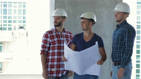 Three Builders Pose At Building Under Stock Footage Sbv 309697825