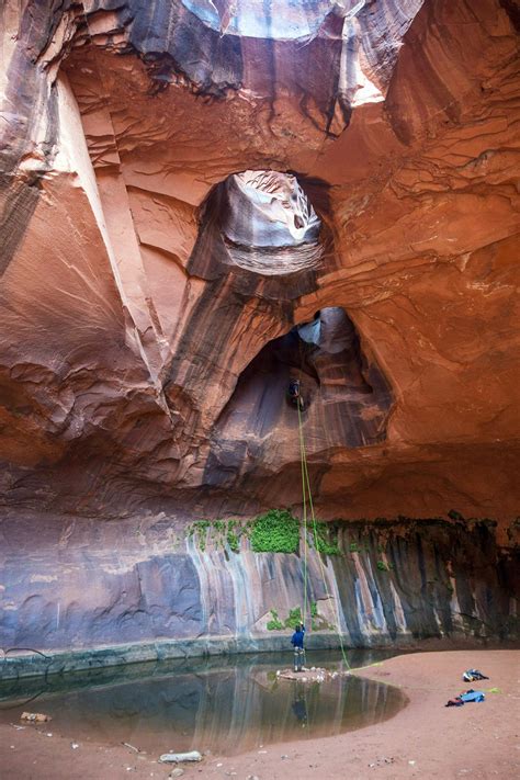 Rappelling Down Golden Cathedral In Neon Canyon Escalante Utah Usa
