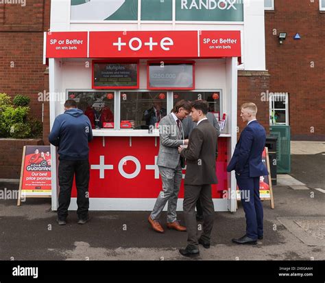 Racegoers placing bets on ladies day during the The Randox Grand
