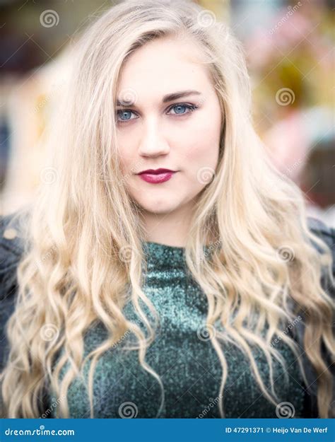 Portrait Of A Beautiful Blond Blue Eyed Teenage Girl In Green To Stock