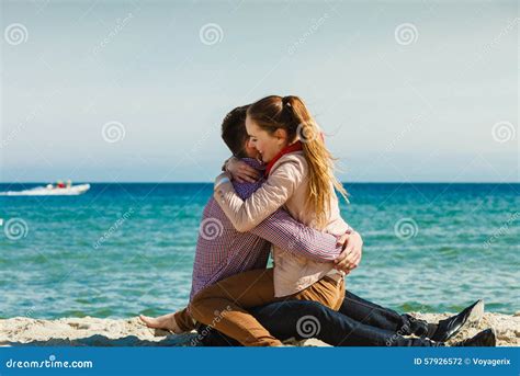 Couple Sitting On Beach Relaxing And Hugging Stock Photo Image Of