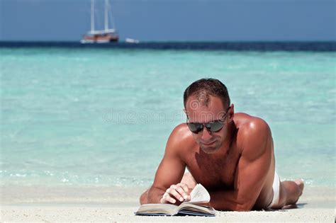 Handsome Man Reading Book At The White Sand Beach Stock Photo Image Of Relaxation Rest