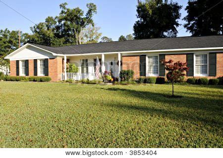 Use them in commercial designs under lifetime, perpetual & worldwide rights. Picture or Photo of Lovely Ranch style home of red brick ...