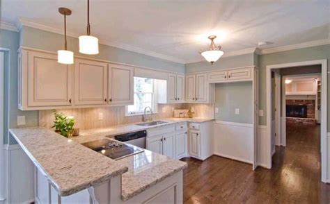 Pairing dark kitchen cabinets with light colored flooring is a classic pair which works timelessly for most design styles. dark floors with cream glazed cabinets and light granite | Kitchen Ideas | Pinterest | Cabinets ...