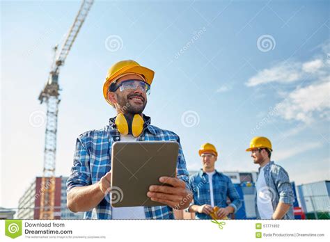 Builder In Hardhat With Tablet Pc At Construction Stock Photo Image