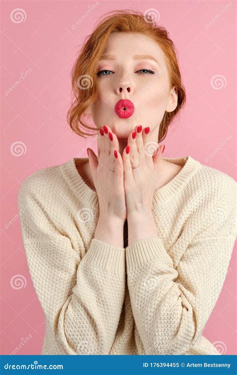 Beautiful Red Haired Girl With Red Lipstick And Manicure Blows A Kiss In The Frame Stock Image
