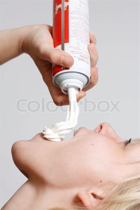 A Young Woman Eating Whipped Cream From Stock Image Colourbox