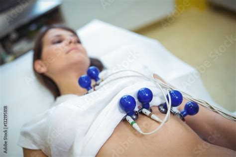Female Patient Undergoing An Electrocardiogram Test Stock Photo And