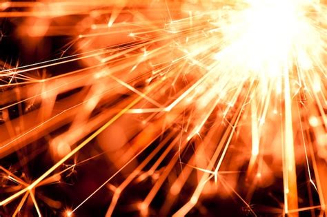 Premium Photo Closeup Of A Bright Orange Fire From A Burning Sparkler