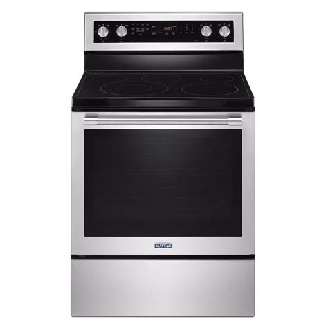 An Electric Range With The Oven Door Open And Its Lights On Against A