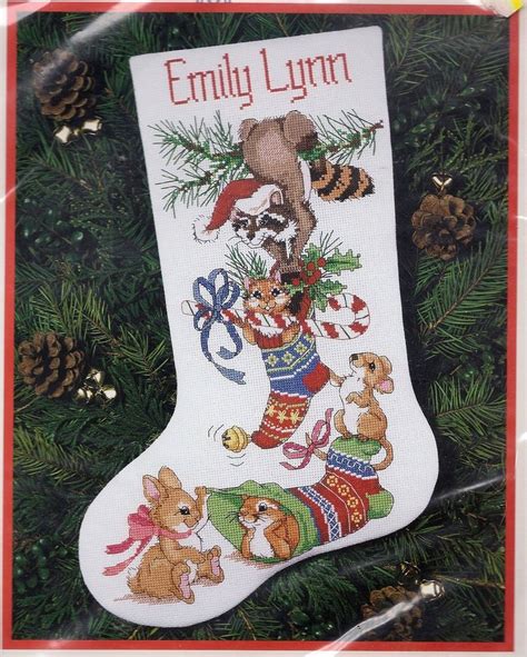 An Embroidered Christmas Stocking Hanging From A Tree With Animals And