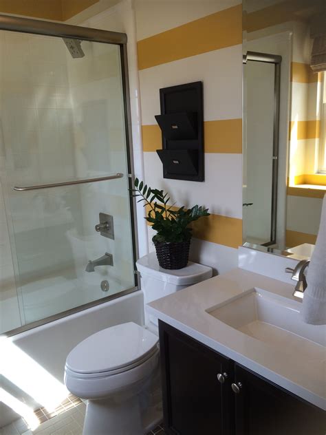 This contemporary vanity design is a nice juxtaposition to the heavily patterned wallcovering in this small but mighty bathroom. great kids bathroom | Bathroom design, Kids' bathroom ...