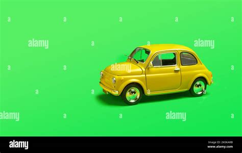 Miniature Yellow Toy Car On Green Background With Copyspace Stock Photo