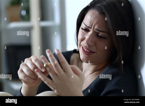 Sad Wife Complaining And Crying Touching Wedding Ring Thinking In Divorce At Home In The Night