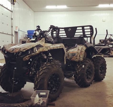 An Atv Is Parked In A Garage With Its Front Wheels Out And Its Seat Up