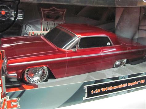 Toy toys remote control low rider car int close up on hard surface very short r. Maisto "Urban G Ridez" 1964 Chevy Impala SS Lowrider 1/12 ...