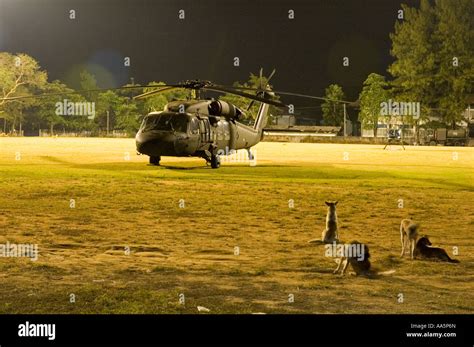 Military Helicopter Stationary On A Landing Pad On A Sports Field In