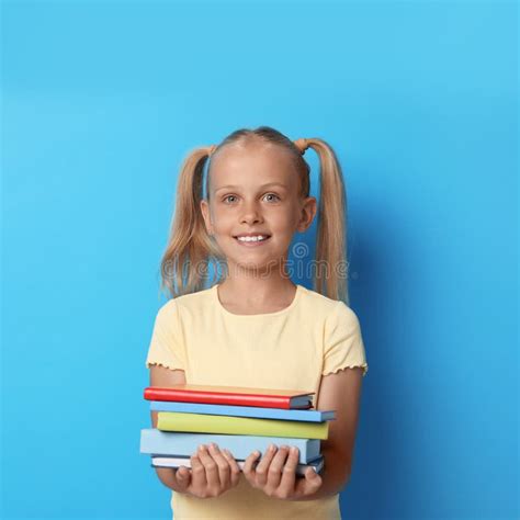 Portrait Of Cute Little Girl With Books On Background Reading Concept