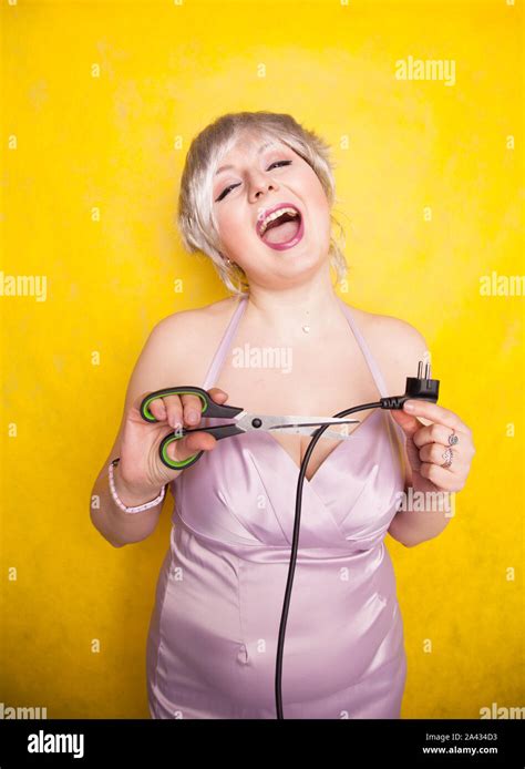 stupid person cuts electric wire with scissors silly blonde in pink dress plays bad with