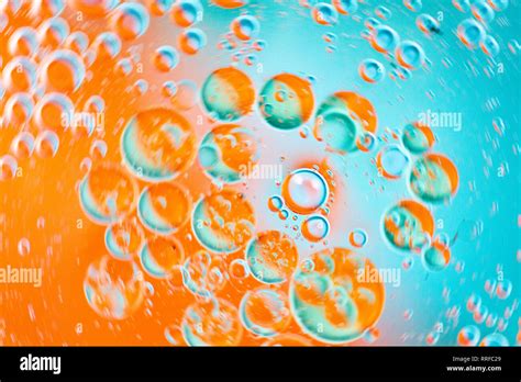 From Above Closeup Many Abstract Orange And Blue Water Bubbles On Glass