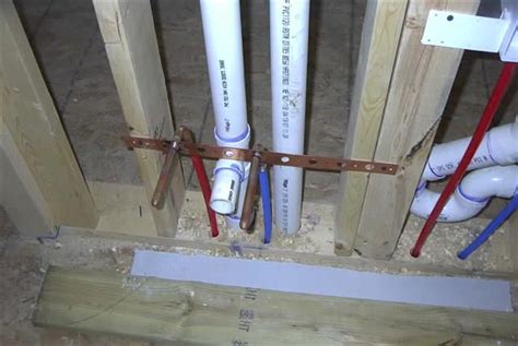 One hole is 4 inches to the right of centerline; bathroom sink pex water line stub out & drain (photo ...