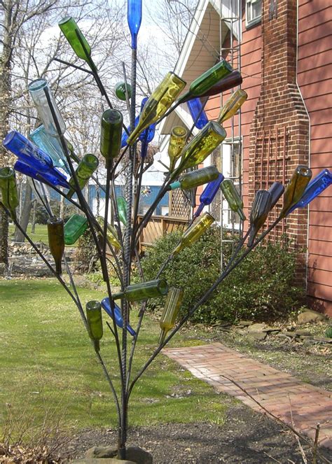 my husband made the bottle tree from rebar garden art diy garden pond garden trees garden
