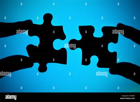 Two Hands Connecting Two Pieces Of Puzzle Stock Photo Alamy