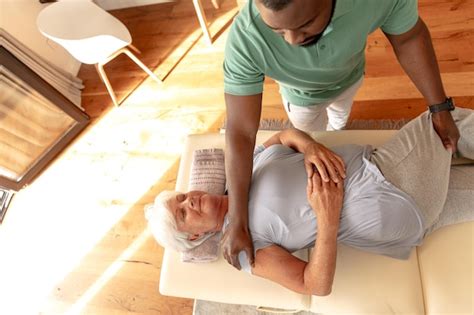 Premium Photo African American Male Physiotherapist Giving Massage Therapy To Caucasian Senior