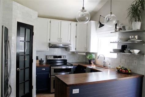 A classic tuxedo kitchen is typically defined by white upper cabinets and black lower cabinets, as in this kitchen from ashton woods, which also incorporates a black center island. The Look- Two Tone Tuxedo Kitchen - Bright Green Door