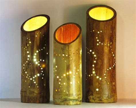 Three Wooden Vases Sitting Next To Each Other On A Table With Lights In