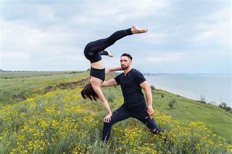 Couple Practicing Acro Yoga Poses Outdoors Outside Pair Of Sportsmen