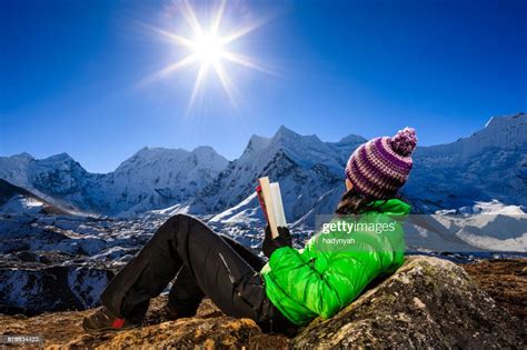 Woman Reading A Book During Sunrise Over Himalayas Everest Region High